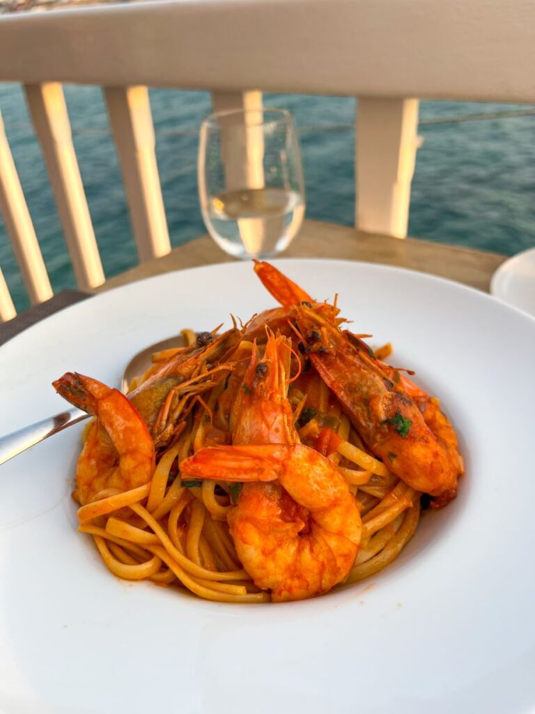 Grilled shrimp in a rich tomato‑sauce bowl served at Katerina’s Restaurant & Bar on the waterfront in Little Venice Mykonos.
