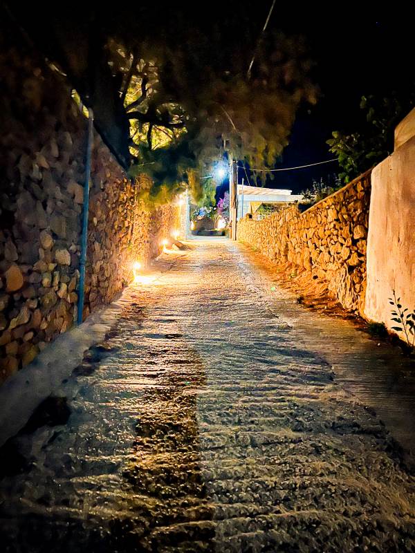Dimly lit alley in Platis Gialos beach in Mykonos at night