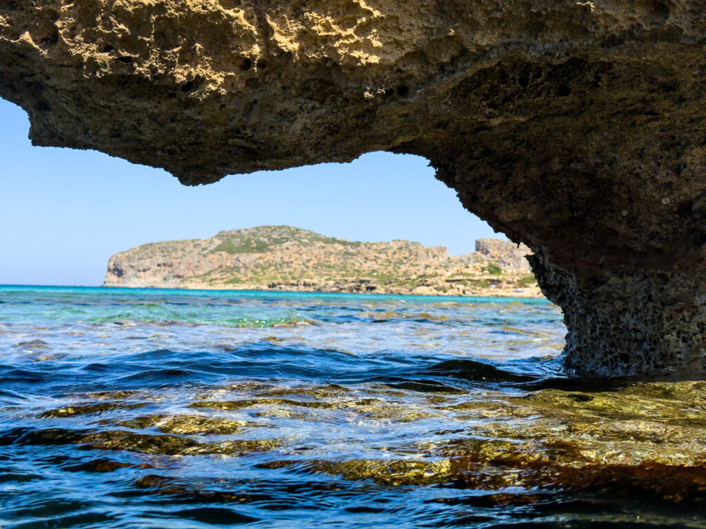 Rock arch with Falasarna beach in background
