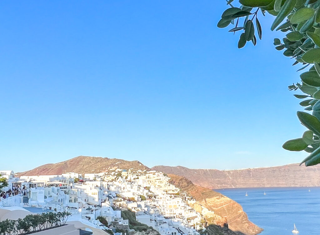 a white buildings on a hill by the water