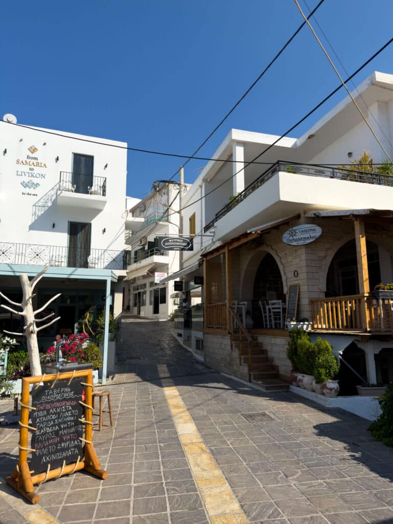 a street with buildings and signs Sfakia Crete