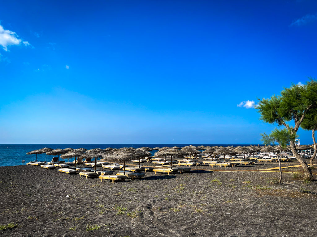 a beach with umbrellas and chairs