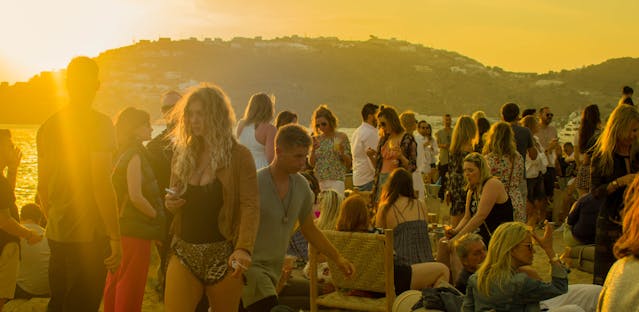 a group of people at a beach Mykonos