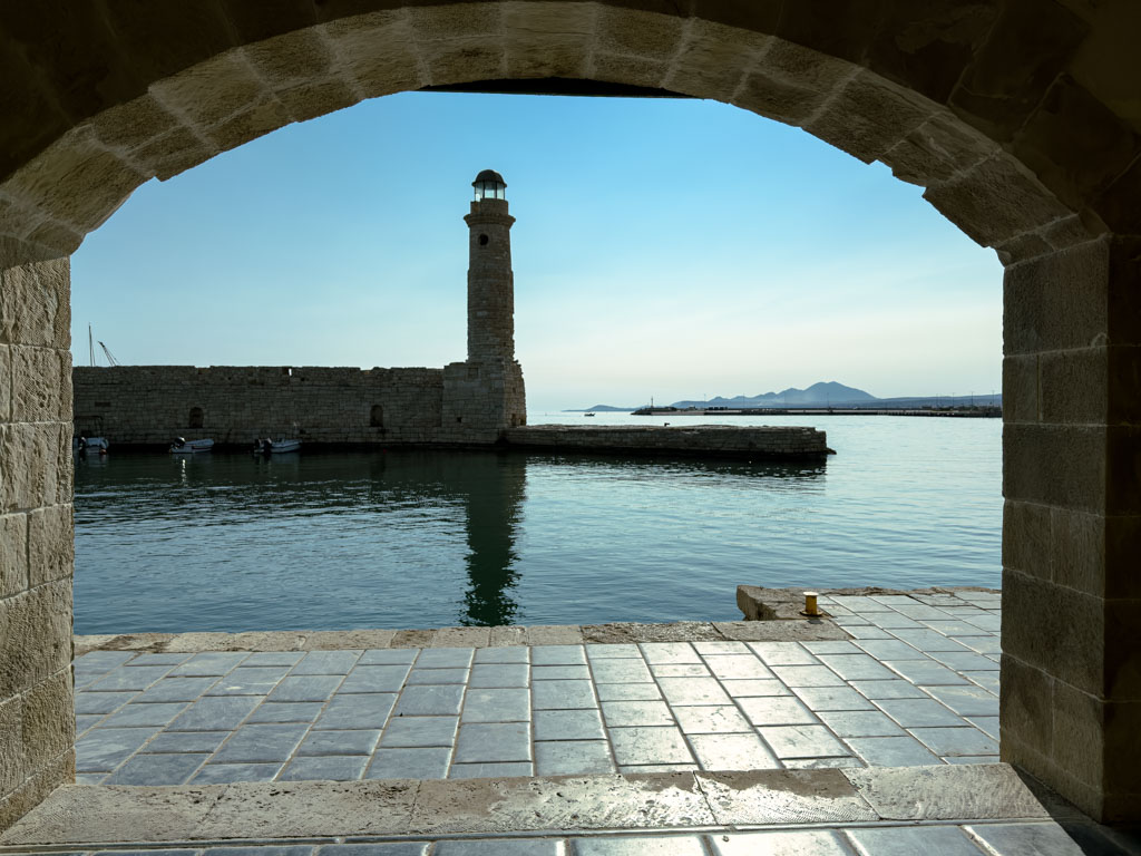a stone structure with a tower in the background